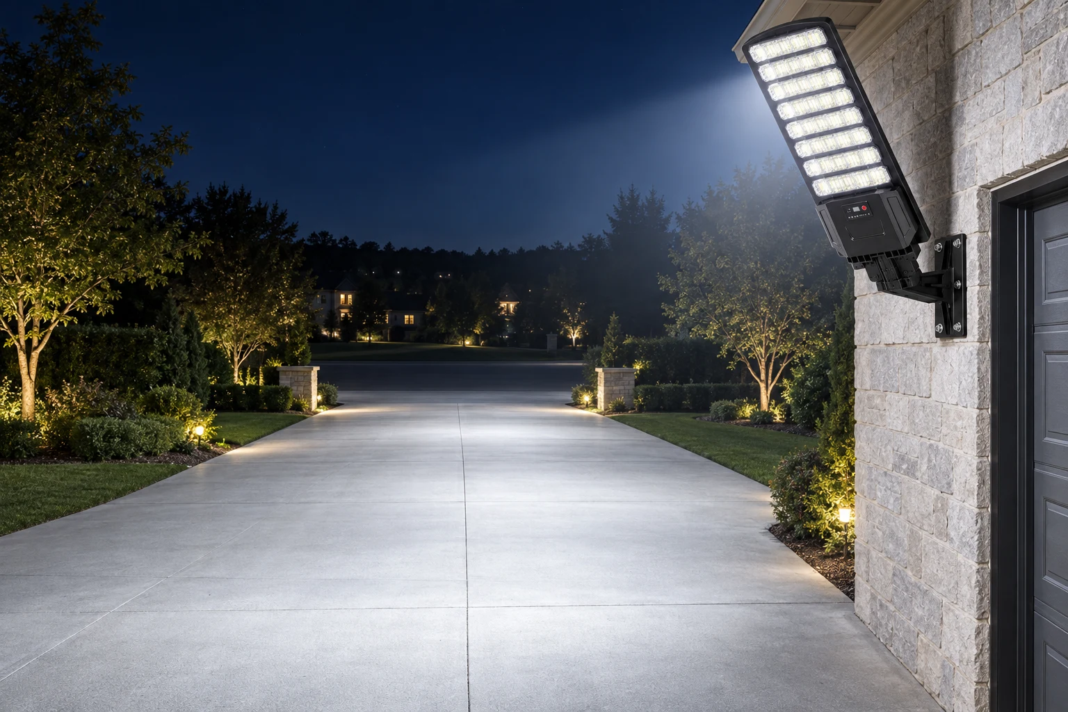 Solar street light lighting a long driveway and parking area at night